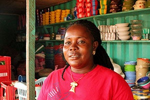 Tina Tuonyon is a 37-year-old single mother who used to sell charcoal at a small market stall. She is now a cross-border trader with a big clothing and household goods shop. Photo: UN Women/Arwen Kidd