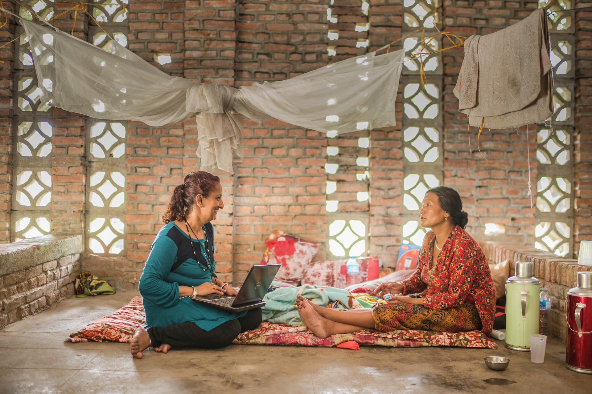 Sujata Sharma Poudel, a psychosocial counsellor, speaks with a local woman at the Women's Rehabilitation Centre in Panchkhal Nepal. Following the 2015 earthquake, Ashmita Tamang, district psychosocial counsellor with Nepal-based Centre for Victims of Torture reiterated that the number of domestic and sexual violence cases she dealt with increased. Photo: UN Women/Samir Jung Thapa.