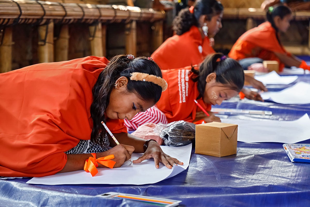 Girls make posters for International Human Rights Day in Cox's Bazar, Bangladesh in December 2023. 