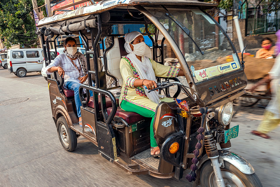 A SEWA community leader is seen here driving an e-rickshaw. With women behind the wheels, women passengers often feel safer because sexual harassment in public spaces and transportation is a persistent problem. It also provides women with jobs in a make dominated sector. Photo: UN Women/ Prashanth VIshwanathan