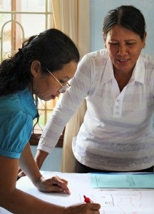 Women in Binh Dinh, Viet Nam, discuss a community action plan for natural disasters. UN Women supports training to strengthen the role of women in disaster risk reduction (DDR) and disaster reduction management.