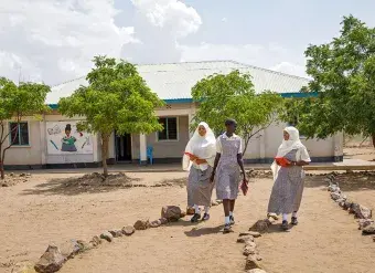 Students on the grounds of the Angelina Jolie Primary School in Kakuma refugee camp, Kenya. Photo: UN Women/Ryan Brown