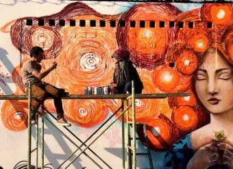 A group of graffiti artists (all young women) painted orange murals in Zone 18 in Guatemala City in support of UN Women and the UNiTE campaign to End Violence against Women. Photo: UN Women/Carlos Rivera