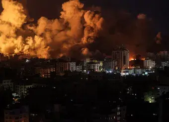 Flames and smoke billow during Israeli strikes in Gaza on 9 October 2023. 