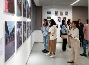 Visitors view exhibited works on 19 October at Raintree, Phnom Penh, Cambodia.