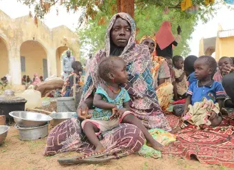 Mariam Djimé Adam, a refugee from Sudan with eight children, is seen in the yard of a secondary school in the neighbouring country of Chad.. 
