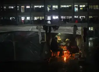 A Palestinian family is seen at a shelter during a rainy night in the city of Rafah, Gaza. Photo: UNICEF/Eyad El Baba