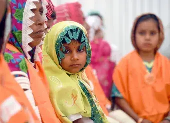 A child looks at the camera during a UN Women event in Pakistan