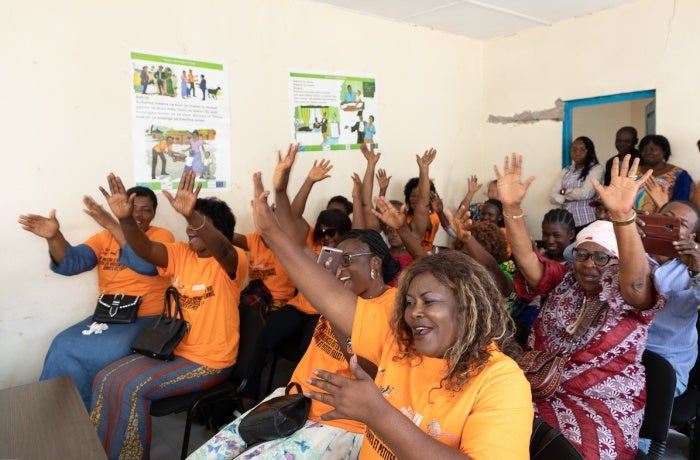 Twenty women vendors from the Mont Mgafula market celebrate receiving their business registration certificates at a ceremony at Mont Ngafula Town Hall on 6 October 2022. Photo: UN Women/Yulia Panevina 