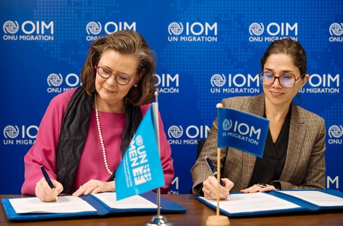 UN Women Deputy Executive Director Kirsi Madi (left) signs a new partnership with Catalina Devandas, IOM Representative of the Director General Office of Partnerships, Advocacy, and Communication.